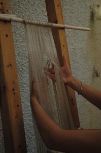 Weaving on the warp-weighted loom. Photo S. Spantidaki.